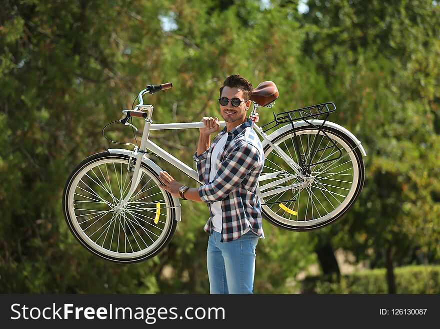 Handsome Young Hipster Man With Bicycle