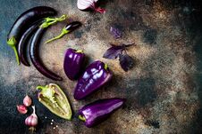 Raw Purple Seasonal Vegetables Over Rustic Background. Top View, Flat Lay. Royalty Free Stock Photo