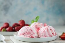 Ice Cream Scoops Of Delicious Ice-cream And Strawberry On White Background. Scoops Of Delicious Ice-cream And Strawberry On White Stock Photos