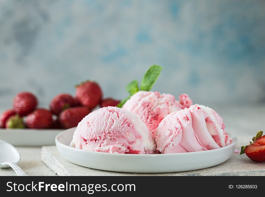 Ice cream Scoops of delicious ice-cream and strawberry on white background. Scoops of delicious ice-cream and strawberry on white