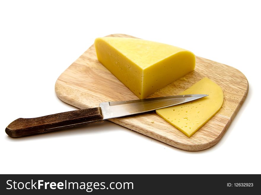 Block of cheese on cutting board with a knife, isolated on white background. Block of cheese on cutting board with a knife, isolated on white background