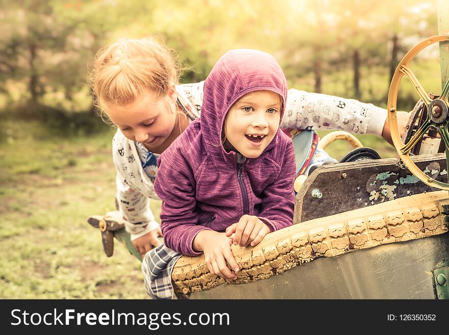 Happy cheerful chidren kids fun playing outdoors park playground yellow sunlight autumn landscape concept happy carefree childhood