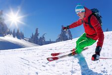 Skier Skiing Downhill In High Mountains Against Blue Sky Stock Image