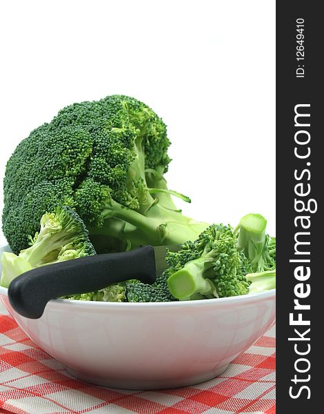 White bowl with broccoli on a checkered cloth