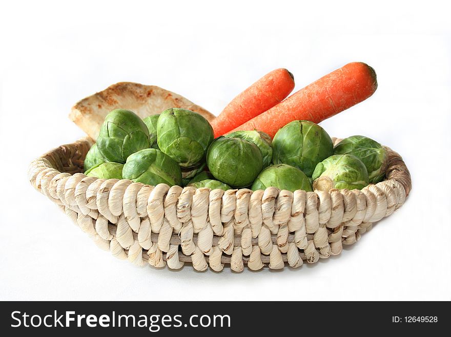 Vegetables in a basket on a white background