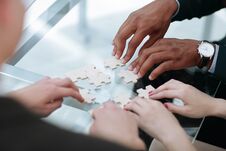 Close Up. Business Team Assembling Puzzle Pieces. Royalty Free Stock Images