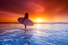 Surfer Woman On Beach At Sunset Royalty Free Stock Photos