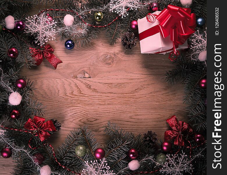 Christmas wreath and gift on wooden background