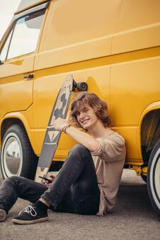 Hipster Guy Sitting Next His Yellow Car During Road Trip Stock Photography