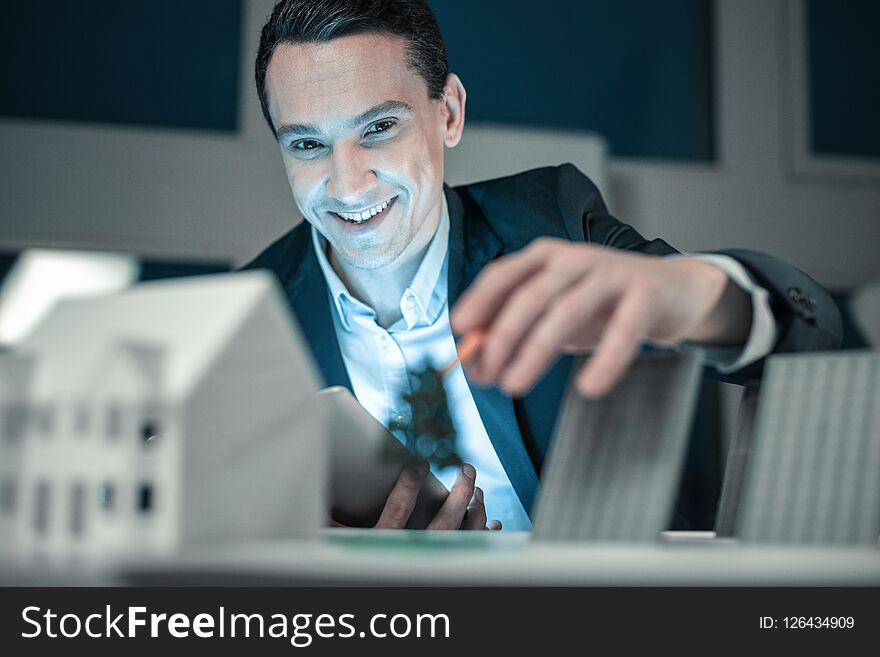 Successful project. Smiling young man finishing his project creating an layout. Successful project. Smiling young man finishing his project creating an layout