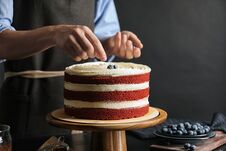 Woman Decorating Delicious Homemade Red Velvet Cake With Blueberries Stock Image