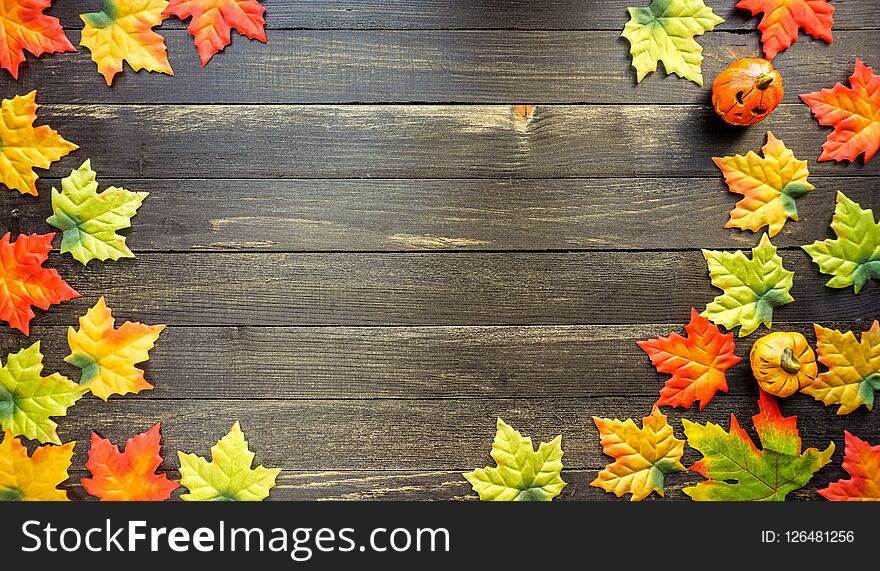 Colorful flat lay of Autumn leaves on rustic wooden table, copy space. Colorful flat lay of Autumn leaves on rustic wooden table, copy space