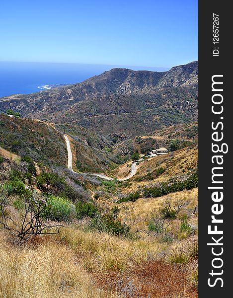 This is a mountain view of the Malibu coast. The shoreline of the Pacific Ocean can be seen in the horizon.