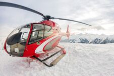 Red Rescue Helicopter Lands Standing In Snowy Mountains Stock Photography