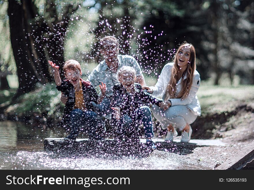 Happy Family Having Fun On The Lake.