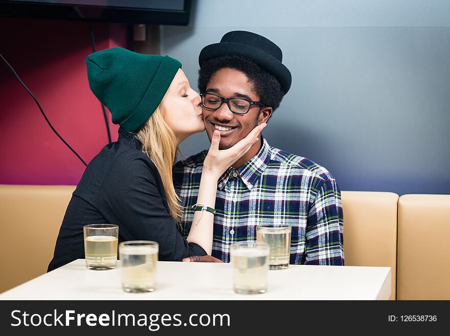 Girlfriend kissing her boyfriend at the restaurant