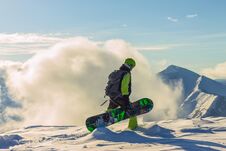 Snowboarder Freerider Is Standing In The Snowy Mountains In Winter Under The Clouds Stock Photography