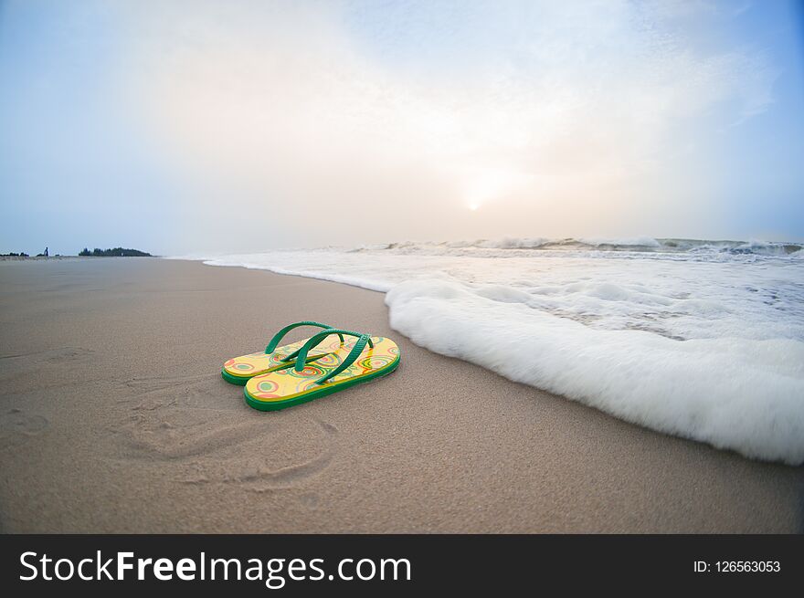 Colorful Flip Flops Lying On Beach In Pondicherry With Waves Sur