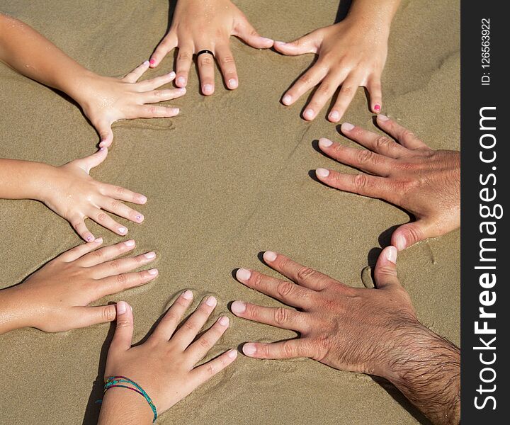 Many hands together on the beach