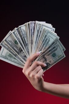 Woman Hand Hand Holding Fan Of Dollars Stock Image