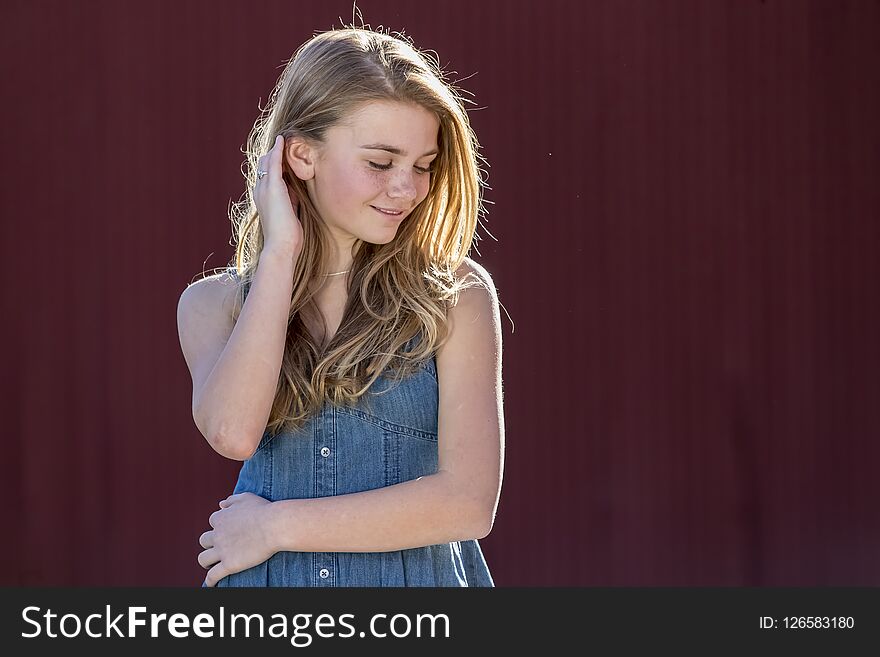 A beautiful young teenage blonde girl enjoying a beautiful day outdoors. A beautiful young teenage blonde girl enjoying a beautiful day outdoors