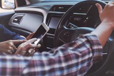 Two People Using Map On Smart Phone In A Car. Royalty Free Stock Image