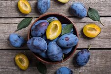 Fresh Plums In Bowl On Wooden Table Royalty Free Stock Photos