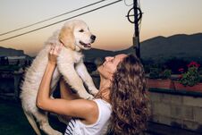 Portrait Of A Woman With Her Puppy Dog In Her Arms Stock Image