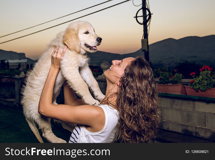 Portrait Of A Woman With Her Puppy Dog In Her Arms