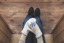 A Girl In The Winter Knitted Mittens With An Iron Mug Of Coffee On The Terrace Of A Wooden House. Royalty Free Stock Images