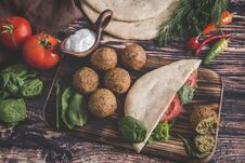 Falafel, Fresh Vegetables ,sauce And Pita Bread On Wooden Table Royalty Free Stock Photos