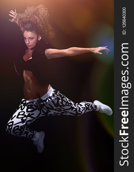 Young woman jumping in the style of street dance