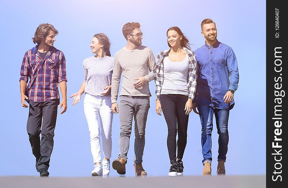 Team Of Young People Walking Along The Road.outdoors