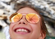 Beautiful Young Girl In Sunglasses With Beach Umbrella Rerlection. Royalty Free Stock Photos