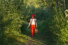 Free Young Girl Walking On A Path Through Green Woods Carrying A Basket Royalty Free Stock Images - 126661029
