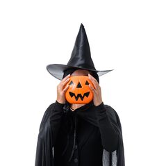 Portrait Of Woman In Black Scary Witch Halloween Costume Standing With Hat Isolated On White Background Stock Photos