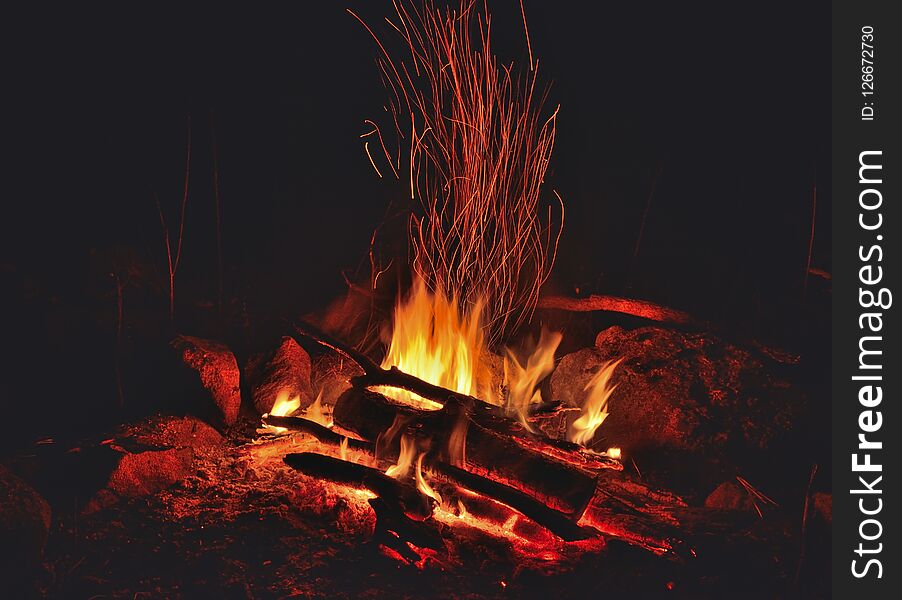 A close up of the aflame bonfire with sparks. A close up of the aflame bonfire with sparks.