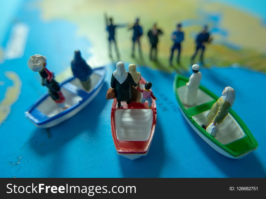 Miniature people concept of Middle Eastern people arrive by boat to the border of USA.