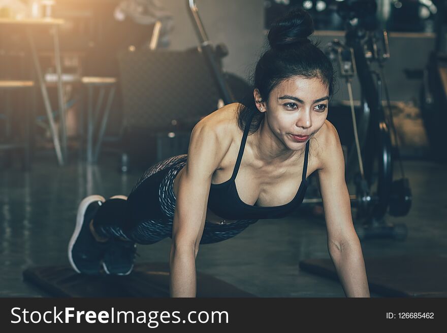 Asian woman intend exercise at gym for healthy.