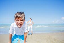 Adorable Boy With His Sister Have Fun On The Beach. Stock Photography