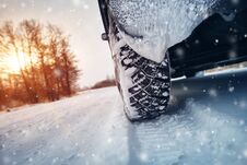 Car Tires On Winter Road Covered With Snow Stock Images