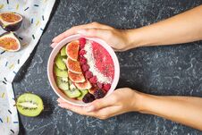 Woman Hands Hold Raspberries Smoothie Bowl With Figs, Kiwi And Coconut On Concrete Background Stock Photos