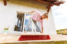 Woman Cleaning Patio Using Brush Broom Royalty Free Stock Photos