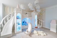 Interior Of A Spacious Children`s Room. Decorative Castle With Bed Inside, Game Slide And Stairs Royalty Free Stock Photos