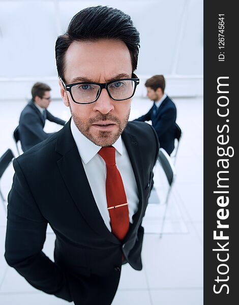 Close up.serious businessman standing in the conference room.business concept