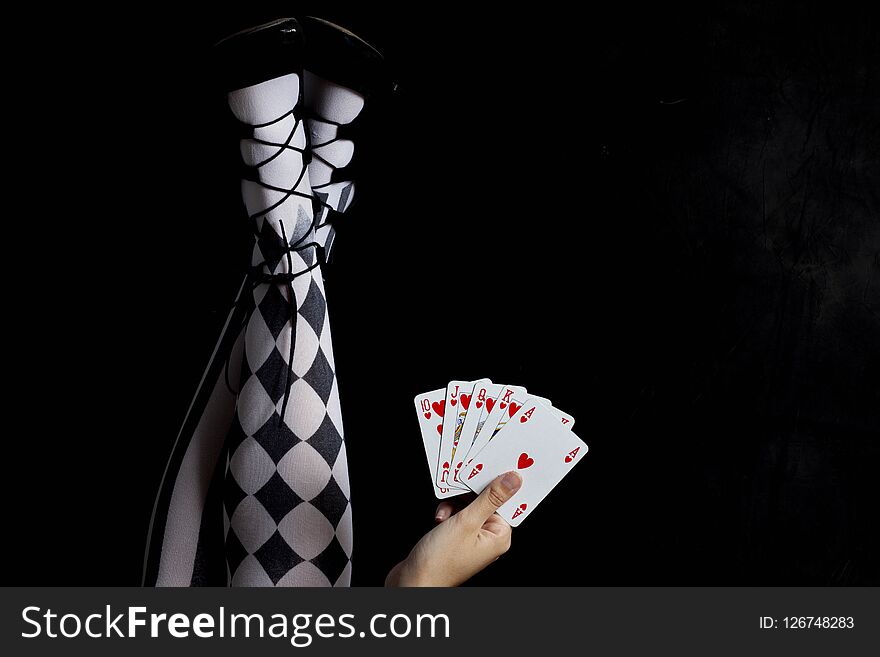 Girl with tights holding play cards - royal flush