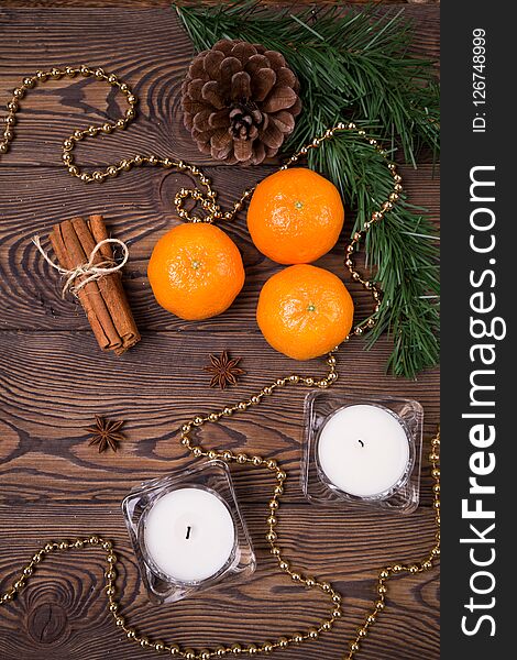 Christmas background - spruce branches with cones, mandarins cinnamon, star anise, Christmas decor. Flat lay, empty space