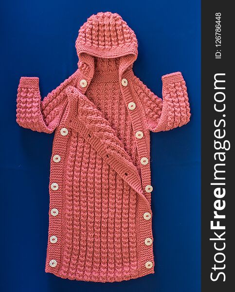 Knitted wool yarn children`s hooded jacket. Knitted wool yarn children`s hooded jacket