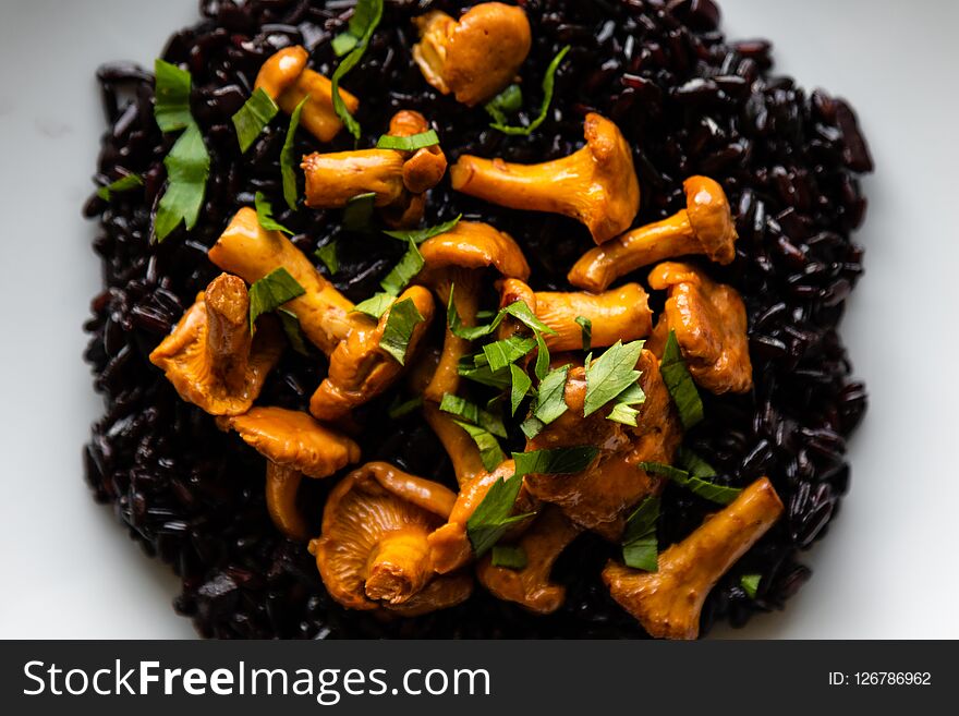 Healthy seared girolles mushrooms with black rice