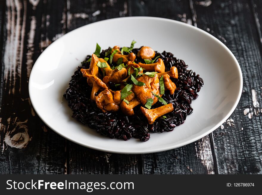 Healthy seared girolles mushrooms with black rice